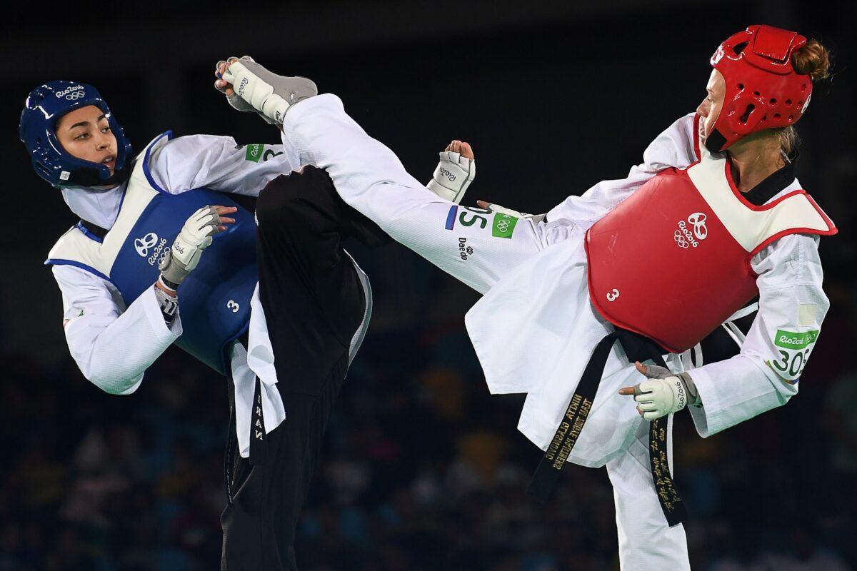Iran's Kimia Alizadeh Zenoorin (L) competes against Sweden's Nikita Glasnovic during their womens taekwondo bronze medal bout in the 57kg category, during 2016 Olympic Games, in Rio de Janeiro, Brazil, on Aug. 18, 2016. (Krill Kudryavtsev/AFP via Getty Images)
