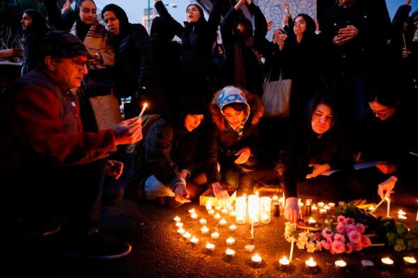 Iranians light candles for the victims of Ukraine International Airlines Boeing 737 during a gathering in front of the Amirkabir University in the capital Tehran, on Jan. 11, 2020. (AFP via Getty Images)