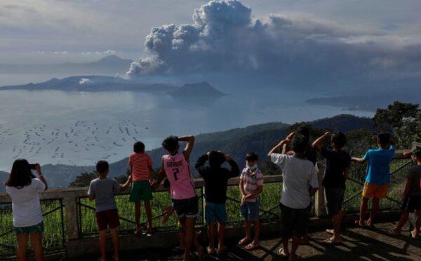 Residents look at the errupting Taal Volcano in Tagaytay City, Philippines, on Jan. 13, 2020. (Eloisa Lopez/Reuters)