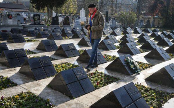 A man walks at the Heroes of the Romanian 1989 Revolution's cemetery during a commemoration on the occasion of the 30 years of the Romanian Revolution's first victims in Timisoara, Romania, on Dec. 15, 2019. (DANIEL MIHAILESCU/AFP via Getty Images)