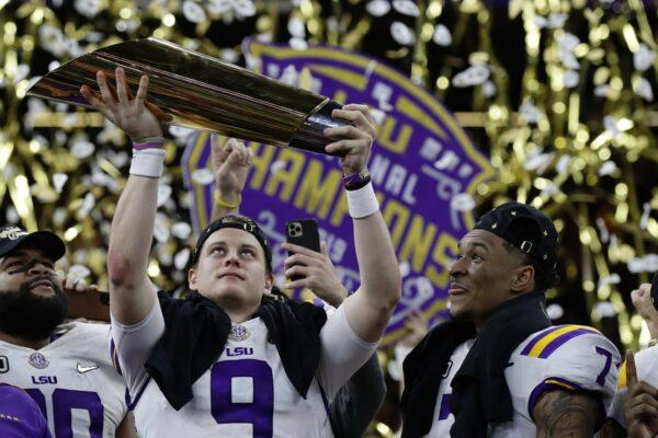 LSU quarterback Joe Burrow holds the trophy as safety Grant Delpit looks on after a NCAA College Football Playoff national championship game against Clemson on Jan. 13, 2020, in New Orleans. LSU won 42-25. (Sue Ogrocki/AP Photo)