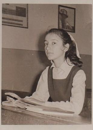 Johnson at her school desk in Romania, a few years before immigrating to the United States. (Courtesy of Ileana Johnson)