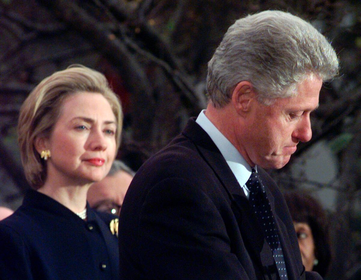 Former First Lady Hillary Rodham Clinton watches President Bill Clinton pause as he thanks those Democratic members of the House of Representatives on Dec. 19, 1998, who voted against impeachment at the White House in Washington. (Susan Walsh/AP Photo)
