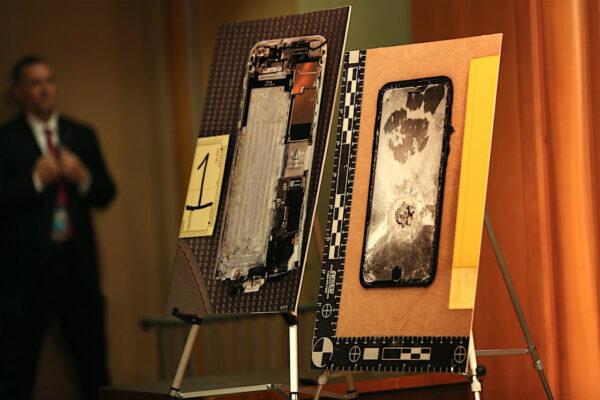 Images of two Apple iPhones that the Pensacola naval base shooter, Royal Saudi Air Force 2nd Lt. Mohammed Alshamrani, tried to destroy are on display at a press conference at the Justice Department in Washington on Jan. 13, 2020. (Charlotte Cuthbertson/The Epoch Times)