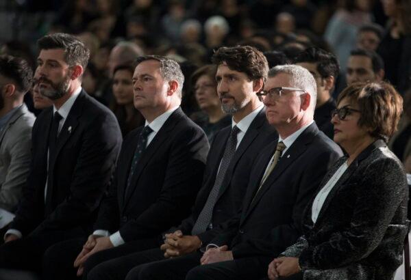 (L-R) Edmonton Mayor Don Iveson, Alberta Premier Jason Kenney, Prime Minister Justin Trudeau, and University of Alberta President David Turpin listen to speeches during a memorial in Edmonton on Jan. 12, 2020, for the victims of the Ukrainian plane disaster in Iran that occurred on Jan. 8. (The Canadian Press/Todd Korol)