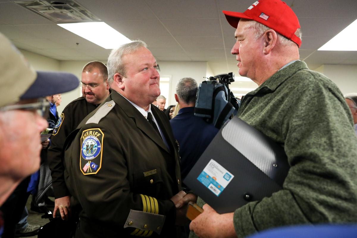 Second Amendment advocates shake hands with Culpeper County Sheriff Scott Jenkins (L) after a hearing where four gun control bills passed the Senate Judiciary Committee at the Virginia State Capitol in Richmond on Jan. 13, 2020. (Samira Bouaou/The Epoch Times)