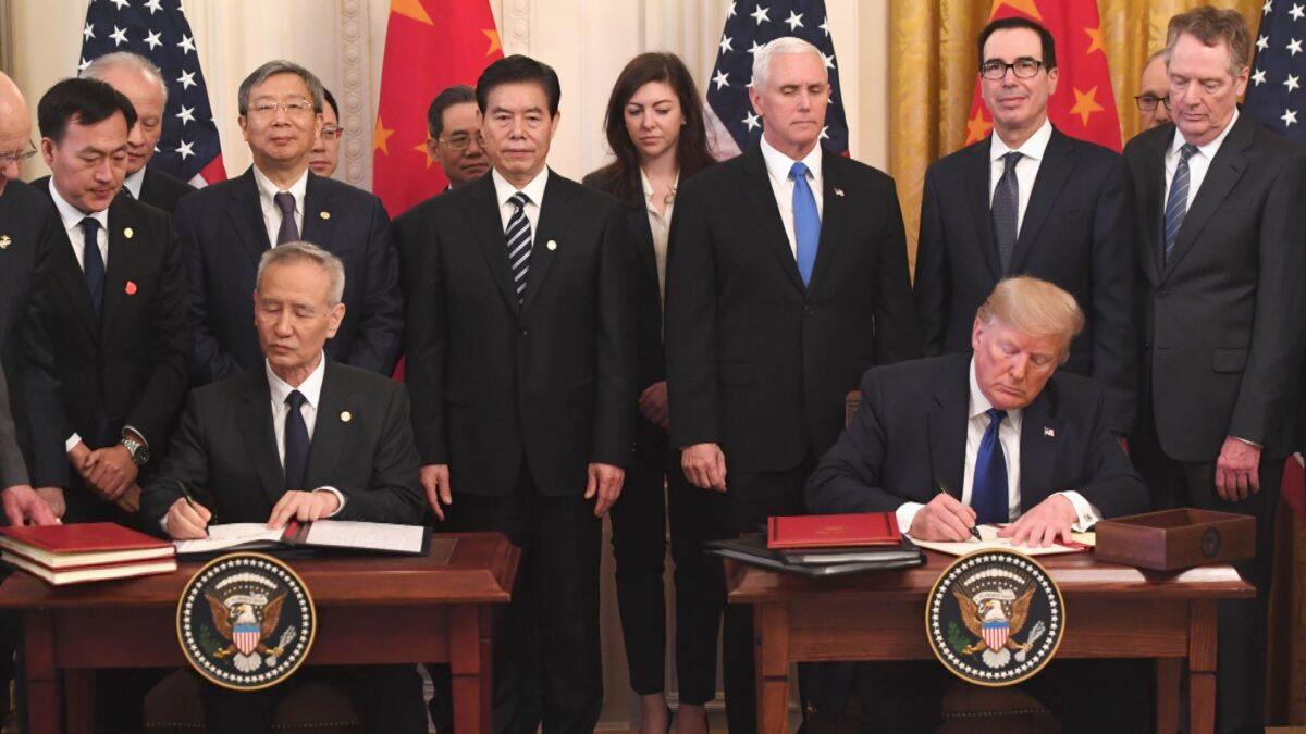 Chinese Vice Premier Liu He and U.S. President Donald Trump sign a trade agreement between the United States and China in the East Room of the White House in Washington on Jan. 15, 2020. (Saul Loeb/AFP/Getty Images)