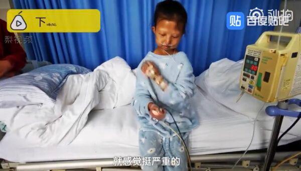 An screenshot from Chinese media of Wu Huayan sitting on a hospital bed in Guiyang city of southwestern China's Guizhou Province in October 2019. (Screenshot via The Epoch Times)