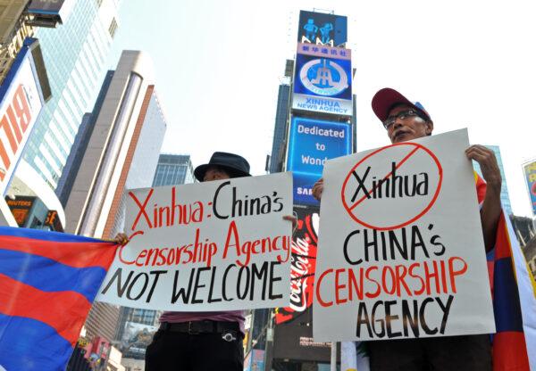 Students for a Free Tibet protest below a new electronic billboard leased by Xinhua (2nd from top), a news agency operated by the Chinese regime, as it makes its debut in New York's Times Square, U.S. on Aug 1, 2011. (Stan Honda/AFP via Getty Images)