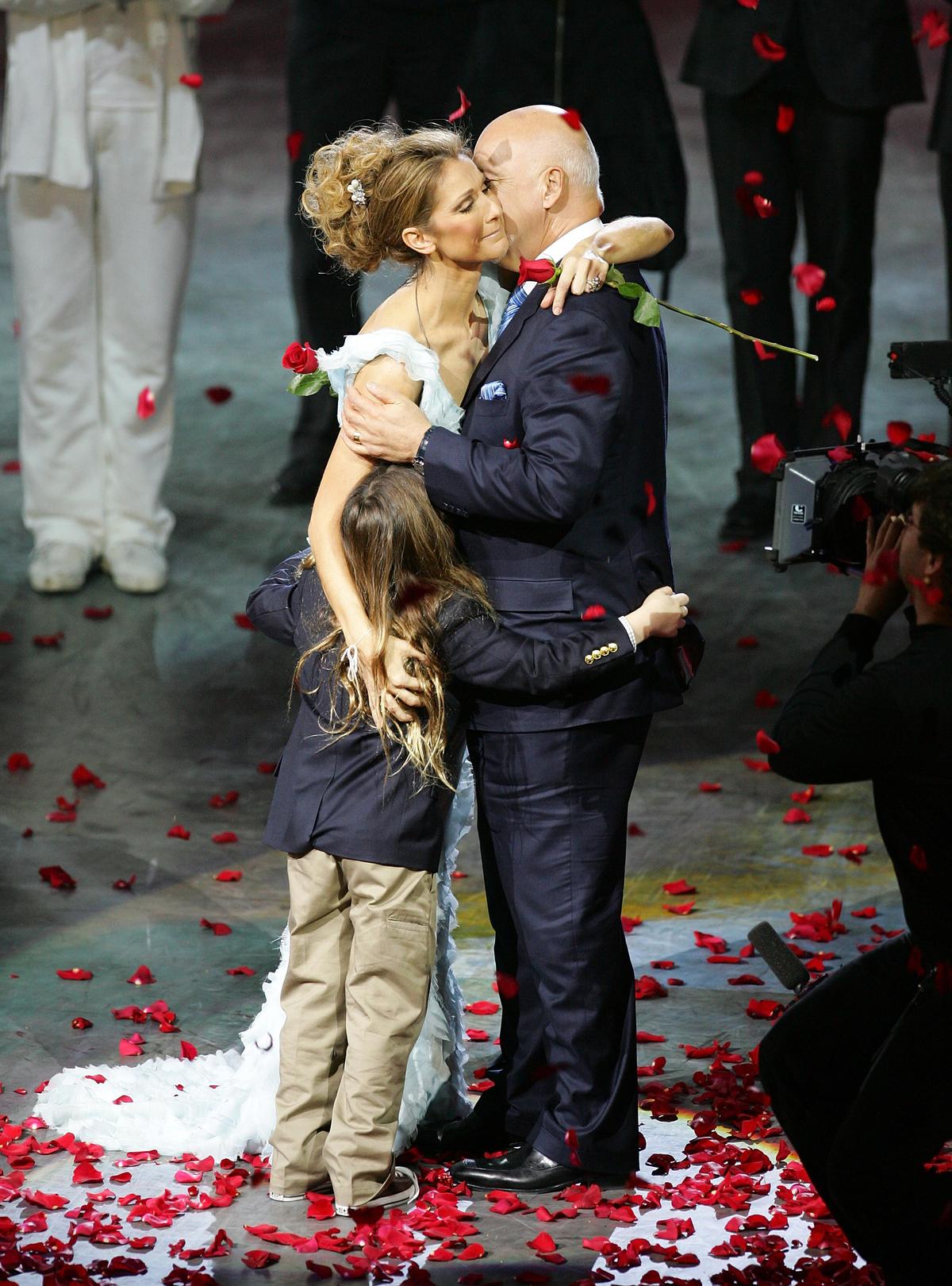 Celine Dion with her husband René Angélil and her son René-Charles Angélil in 2007 (©Getty Images | <a href="https://www.gettyimages.com.au/detail/news-photo/singer-celine-dion-is-embraced-by-her-husband-and-manager-news-photo/78504223">Ethan Miller</a>)