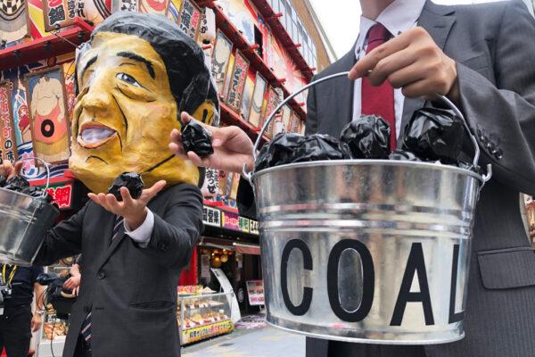 Protesters demonstrate against coal use during the G20 summit in Osaka, Japan, on June 28, 2019. (Pak Yiu/AFP via Getty Images)