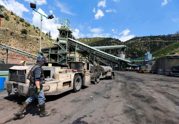 A coal miner walks past mining equipment at the Sufco Coal Mine, 30 miles east of Salina, Utah, on May 28, 2014. Sufco is one of four mines operated by Wolverine Fuels, a company that has threatened to sue the city of Richmond, Calif., if it imposes a ban on coal that would cut off a major export port for Wolverine. (George Frey/Getty Images)