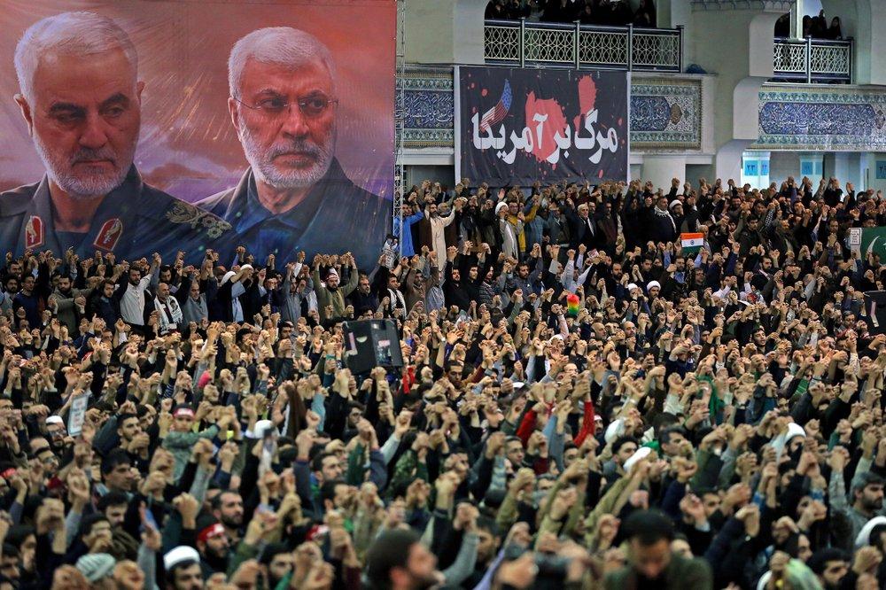 Worshippers chant slogans during a Friday prayers ceremony at Imam Khomeini Grand Mosque in Tehran, Iran, on Jan. 17, 2020, as a banner shows Iranian Revolutionary Guard Gen. Qassem Soleimani, left, and Iraqi Shiite senior militia commander Abu Mahdi al-Muhandis, who were killed in Iraq in a U.S. drone attack on Jan. 3, and a banner which reads in Persian: "Death To America." (Office of the Iranian Supreme Leader via AP)