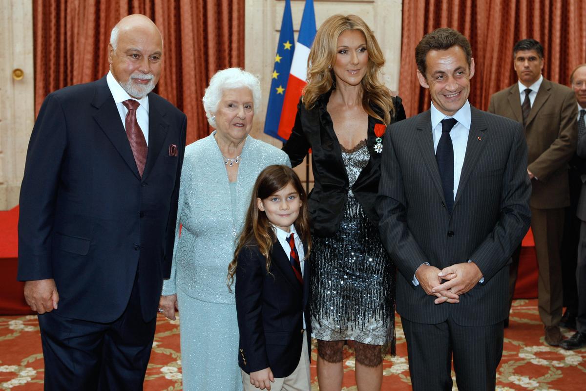 Canadian singer Celine Dion, husband Rene Angelil, her son, Rene-Charles, her mother Therese, and former French President Nicolas Sarkozy after she was awarded with France's Legion d'Honneur during a ceremony at the Elysee Palace in Paris in 2008 (©Getty Images | <a href="https://www.gettyimages.com/detail/news-photo/canadian-singer-celine-dion-poses-with-her-husband-rene-news-photo/81206552">CHARLES PLATIAU/AFP</a>)