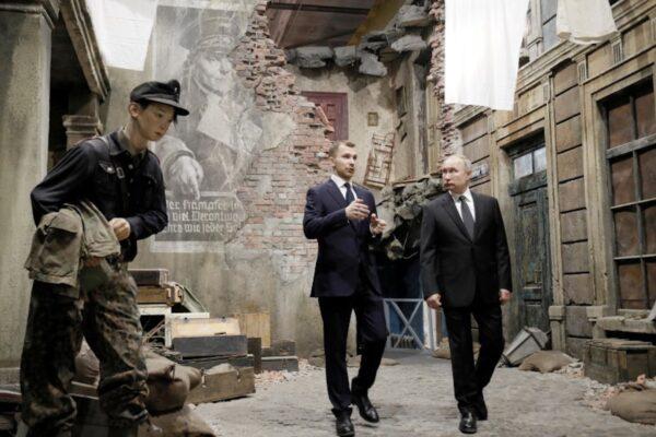 Russian President Vladimir Putin, right, examines an exhibition depicting a Berlin street after surrender in 1945 at 3D panorama 'Memory speaks. The road through the war' in St. Petersburg, Russia, on Jan. 18, 2020. (Dmitri Lovetsky/Pool via Reuters)