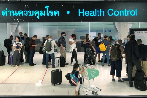 Tourist line-up in a health control at the arrival section at Suvarnabhumi international airport in Bangkok, Thailand, on Jan. 19, 2020. (Jorge Silva/Reuters)