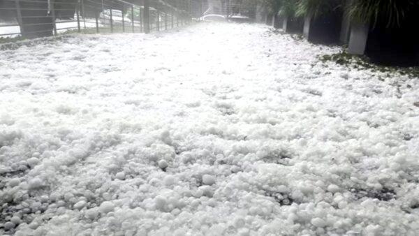 Pathway covered with hail stones in Canberra, Australia, on Jan. 19, 2020. (Still image from video via Reuters)