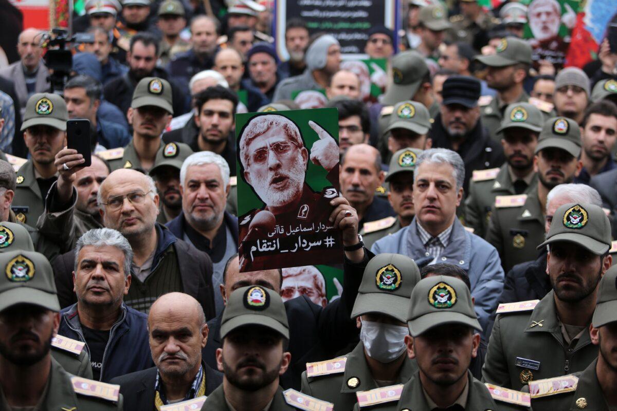 Iranians raise portraits of the newly-appointed head of the Islamic Revolutionary Guards Esmail Qaani during an anti-U.S. rally to protest the killings during a U.S. airstrike of Iranian military commander Qassem Soleimani and Iraqi paramilitary chief Abu Mahdi al-Muhandis, in the capital Tehran on Jan. 4, 2020. (Atta Kenare/AFP via Getty Images)