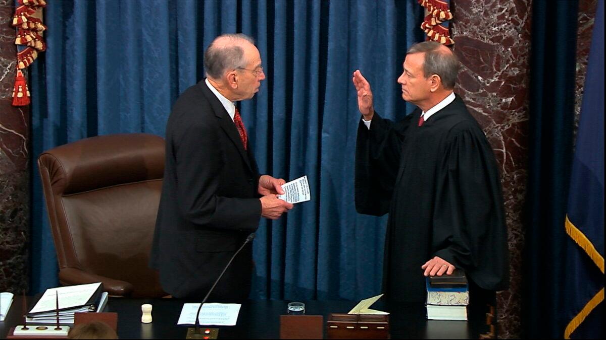 Presiding officer Supreme Court Chief Justice John Roberts swears in members of the Senate for the impeachment trial against President Donald Trump at the U.S. Capitol in Washington on Jan. 16, 2020, in this image from video. (Senate Television via AP)