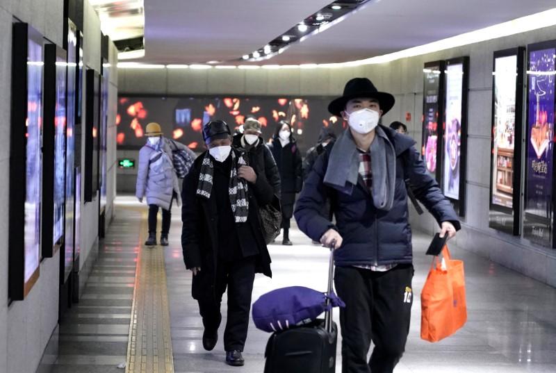 People wearing masks walk through an underground passage to the subway in Beijing, China on Jan. 21, 2020. (Jason Lee/Reuters)
