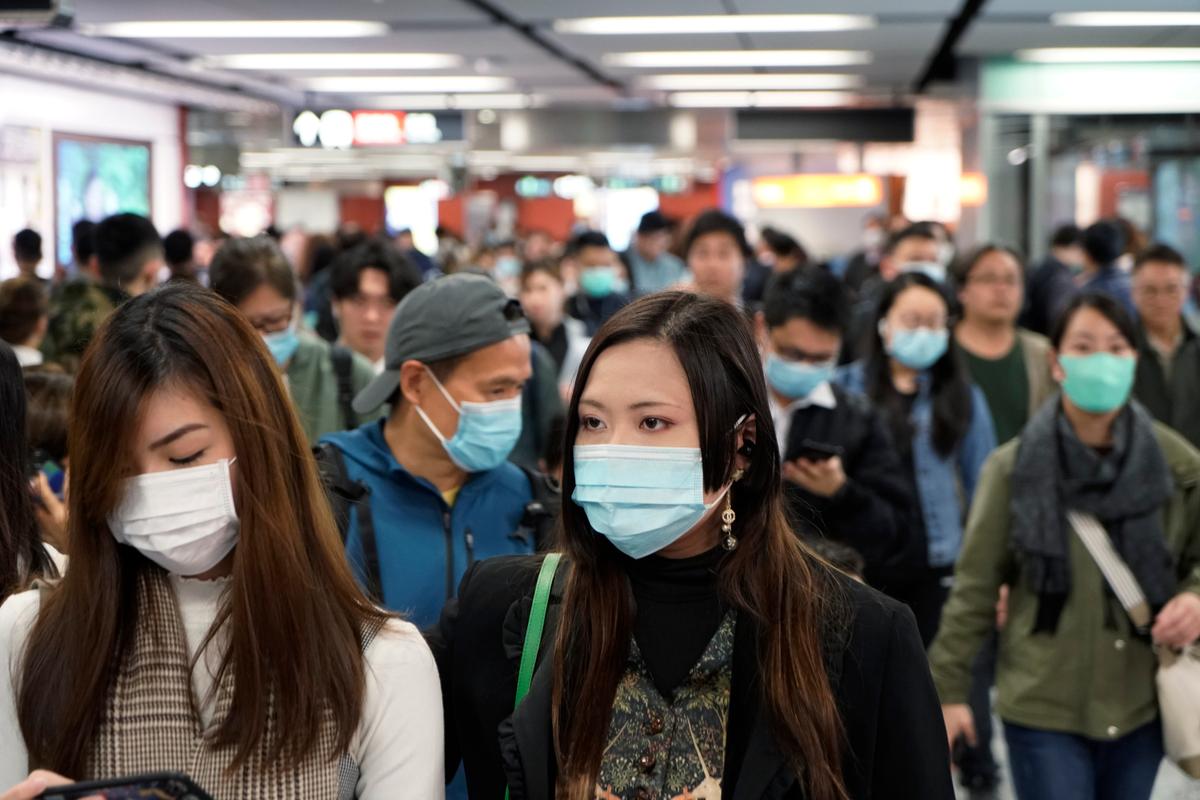 Passengers wear masks to prevent an outbreak of a new coronavirus in a subway station, in Hong Kong on Jan. 22, 2020. (Kin Cheung/AP Photo)