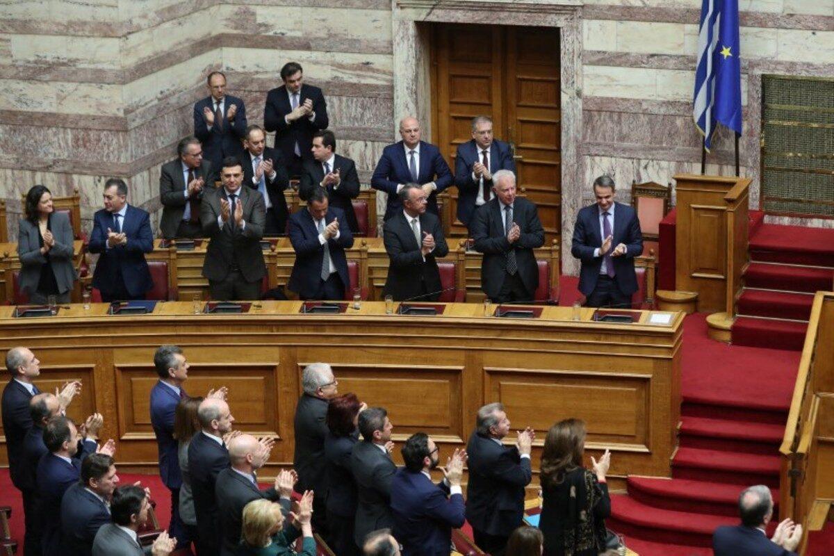 Greek Prime Minster and ministers of the government applaud after the announcement of the results of a presidential vote at the parliament in Athens, Greece, on Jan. 22,2020. (Costas Baltas/ Reuters)