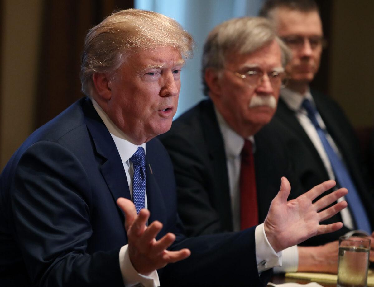 President Donald Trump is flanked by then-national security adviser John Bolton as he speaks in Washington in 2018. (Mark Wilson/Getty Images)