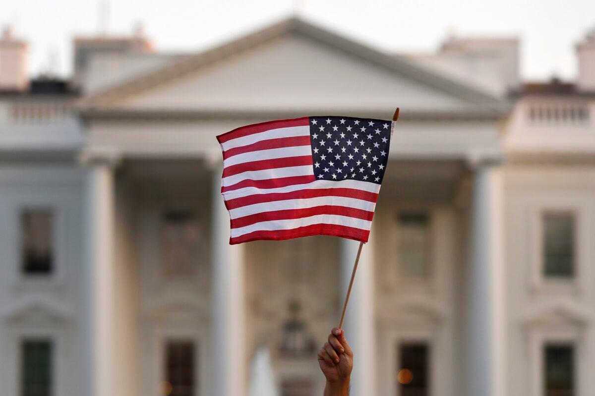 In this September 2017 file photograph, a flag is waved outside the White House, in Washington. The Trump administration is planning on cracking down on birth tourism. (Carolyn Kaster/AP Photo)