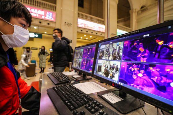 A staff member screens arriving passengers with thermal scanners at Hankou railway station in Wuhan, in China's central Hubei province on Jan. 21, 2020.(AFP via Getty Images)