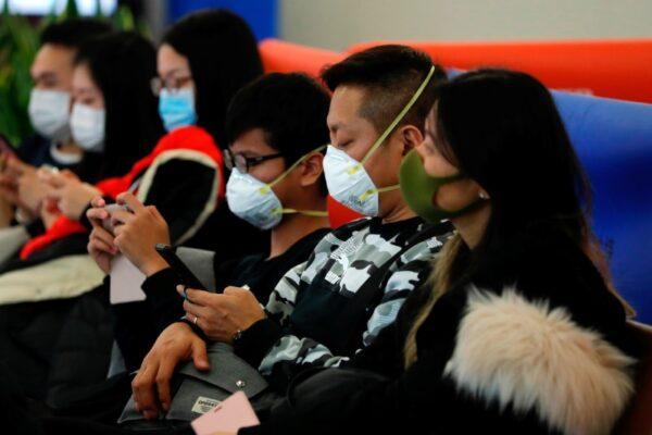 Passengers wear masks to prevent an outbreak of a new coronavirus at the Hong Kong West Kowloon High Speed Train Station, in Hong Kong, China, on Jan. 23, 2020. Tyrone Siu/Reuters)