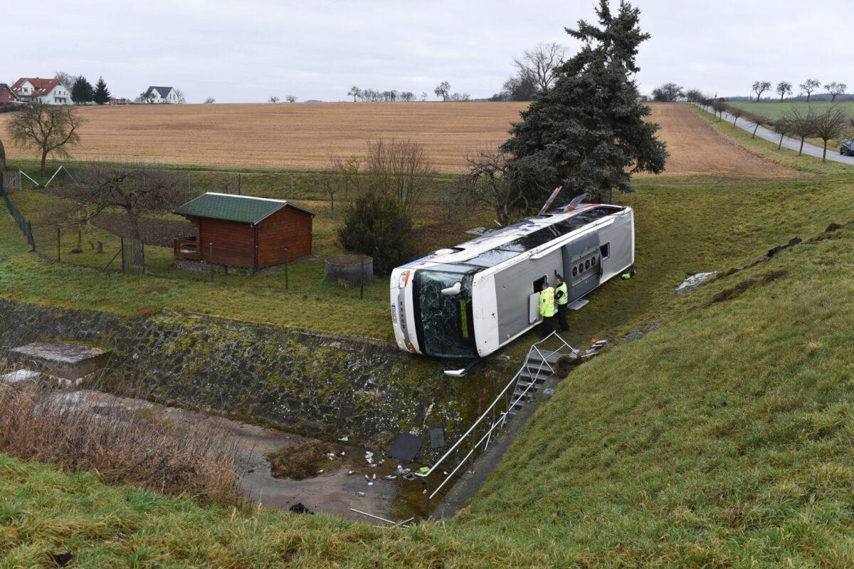 Police officers investigates a school bus that has crashed in Berka Vor Dem Hainich, near Eisenach, Germany, on Jan. 23, 2020. (Swen Pfoertner/dpa via AP)