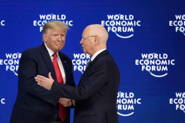President Donald Trump (L) shakes hands with World Economic Forum (WEF) founder and executive chairman Klaus Schwab after he delivered a speech at the Congress centre during the WEF annual meeting in Davos on Jan. 21, 2020. (Fabrice Coffrini/AFP via Getty Images)