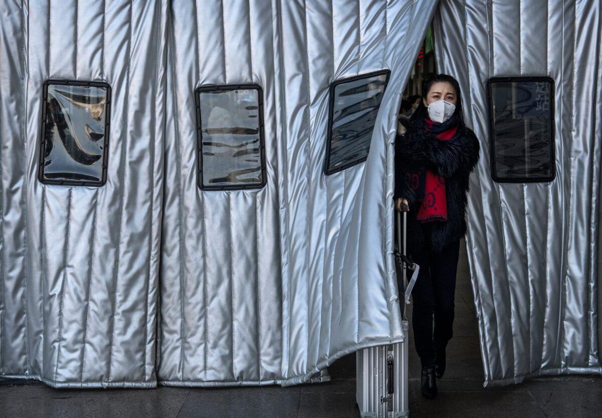 A Chinese woman wears a protective mask as she leaves a Beijing railway station in China on Jan. 23, 2020. (Kevin Frayer/Getty Images)