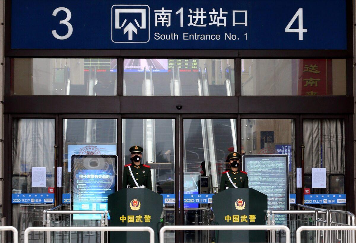 Chinese paramilitary officers wearing masks stand guard at an entrance of the closed Hankou Railway Station after the city was locked down following the outbreak of a new coronavirus in Wuhan, Hubei Province, China, on Jan. 23, 2020. (China Daily via Reuters)
