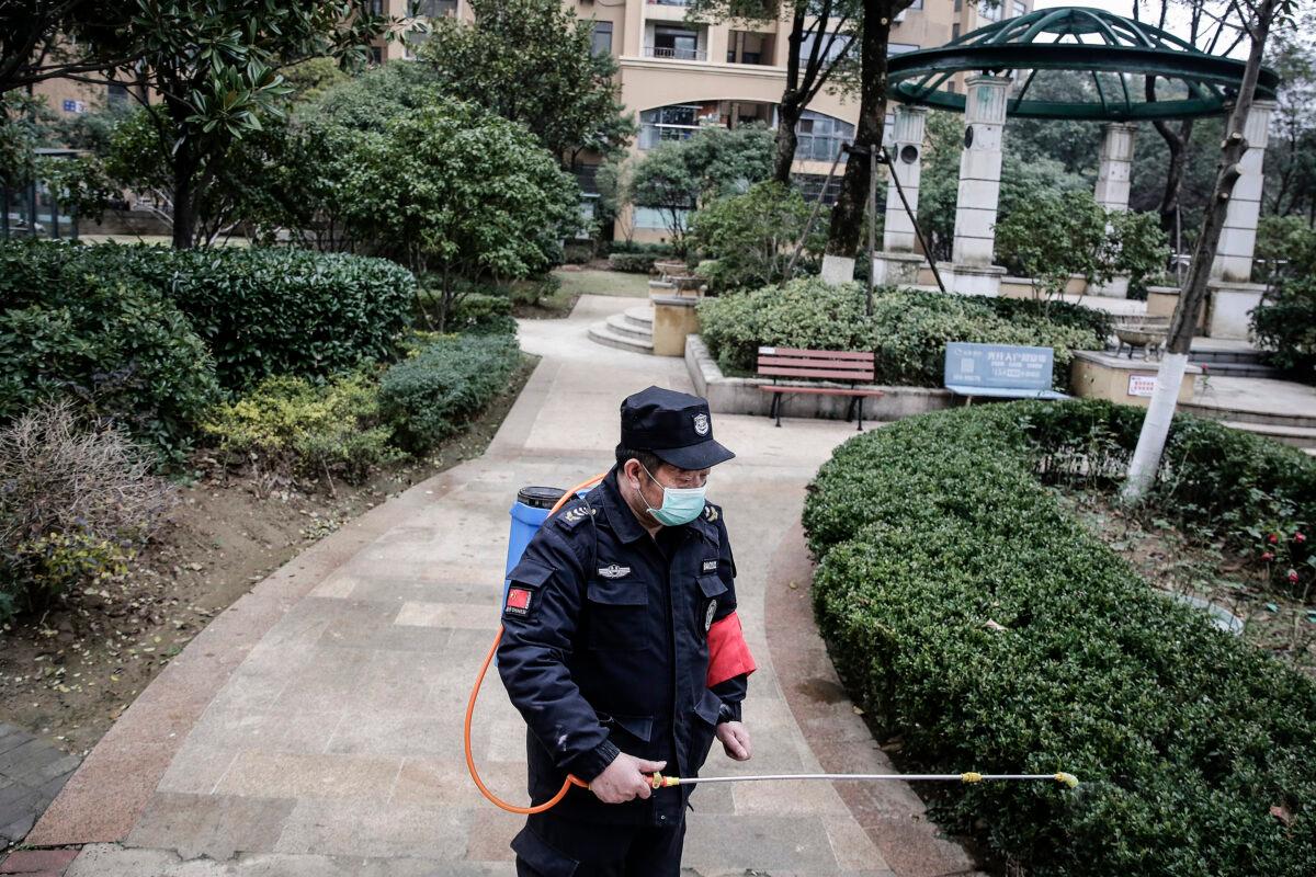 A security guard sprays alcohol to disinfect areas in Wuhan, China on Jan. 23, 2020, amid a quarantine there. (Getty Images)