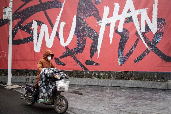A woman wears a mask while riding an electric bicycle in Wuhan, Hubei province, China, on Jan. 22, 2020. (Getty Images)