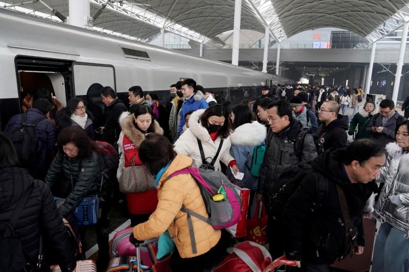 Travelers board a train in China as the annual Spring Festival travel rush begins ahead of the Chinese Lunar New Year, in Shijiazhuang, Hebei Province, China on Jan. 10, 2020. (Jason Lee/Reuters)