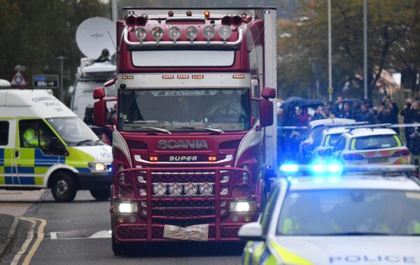 Police officers drive away a lorry (C) in which 39 dead bodies were discovered sparking a murder investigation at Waterglade Industrial Park in Grays, east of London, Britain, on Oct. 23, 2019. (Ben Stansall/AFP via Getty Images)
