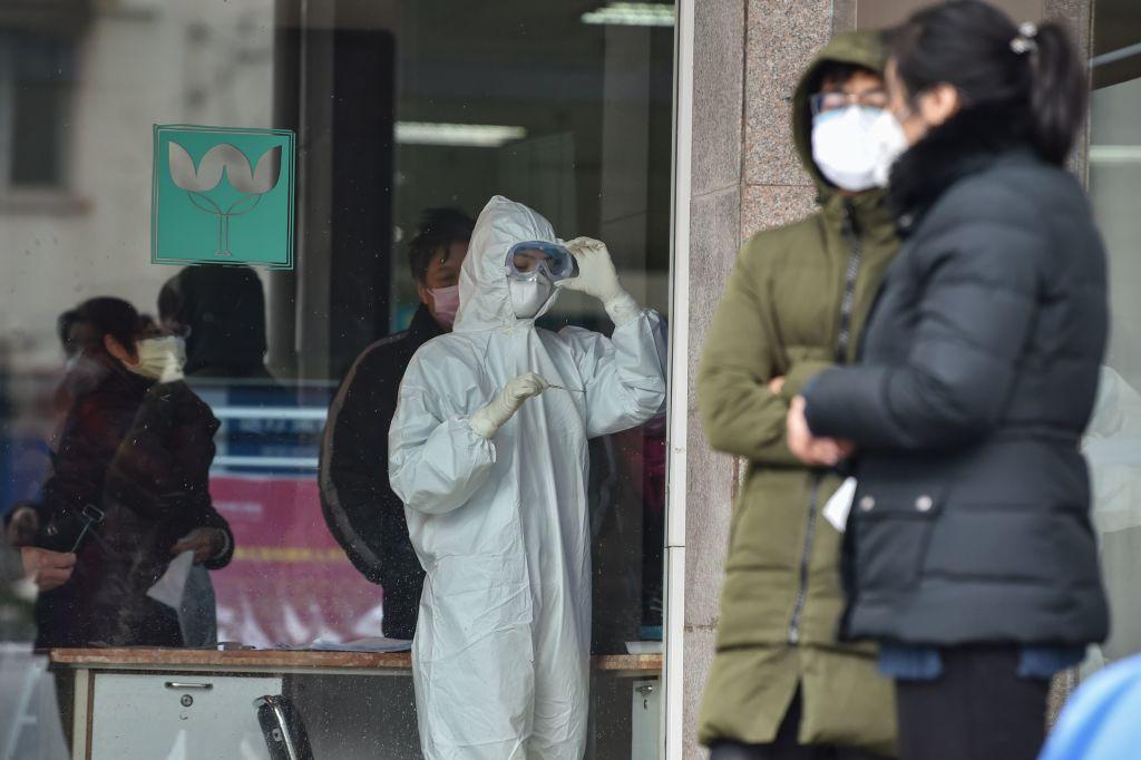 A nurse (C), wearing protective clothing to help stop the spread of a deadly virus which began in the city, looks at a thermometer at the Wuhan Fifth Hospital in Wuhan on Jan. 24, 2020. (Hector Retamal/AFP via Getty Images)