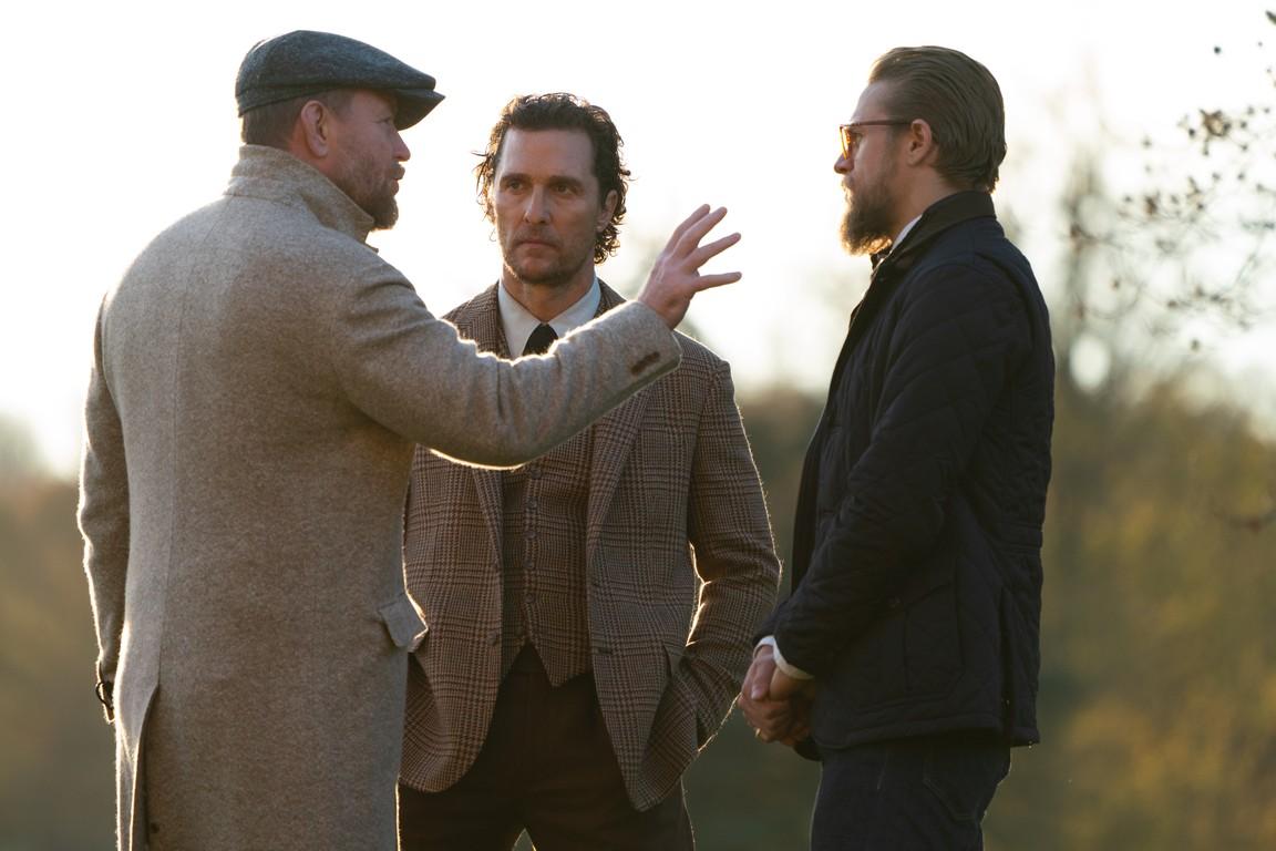 (L–R) Guy Ritchie directing Matthew McConaughey and Charlie Hunnam, who star in “The Gentlemen.” (Christopher Raphael/STX Films)