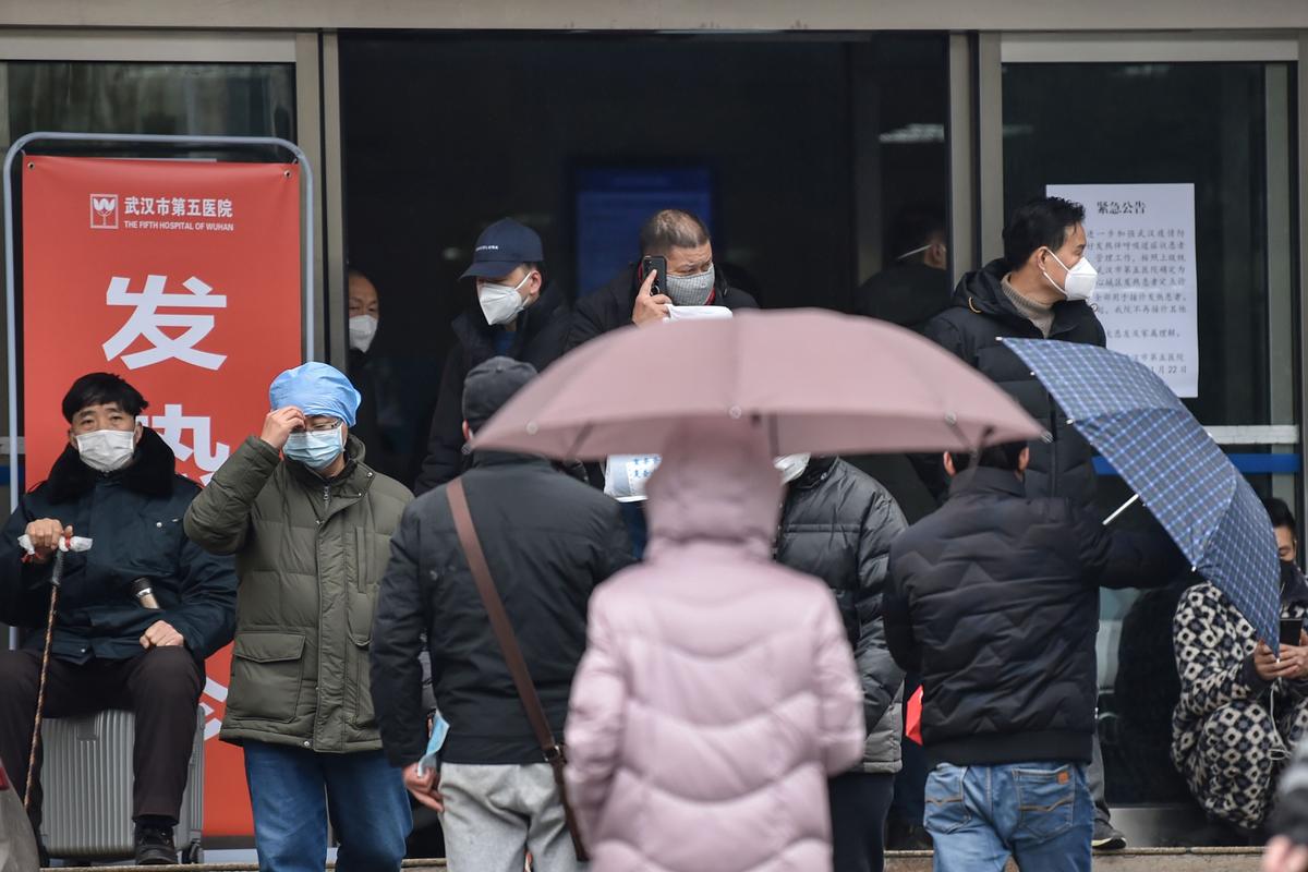 People wearing facemasks to help stop the spread of a deadly virus which began in the city, walk outside the Wuhan Fifth Hospital in Wuhan in China's central Hubei Province on Jan. 24, 2020. (Hector Retamal/AFP via Getty Images)