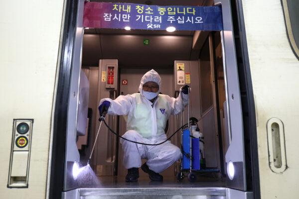 A worker wearing protective gear sprays antiseptic solution in a train amid concerns over the spread of the 2019 Novel Coronavirus, also known as the Wuhan coronavirus, in Seoul, South Korea on Jan. 24, 2020. (Chung Sung-Jun/Getty Images)