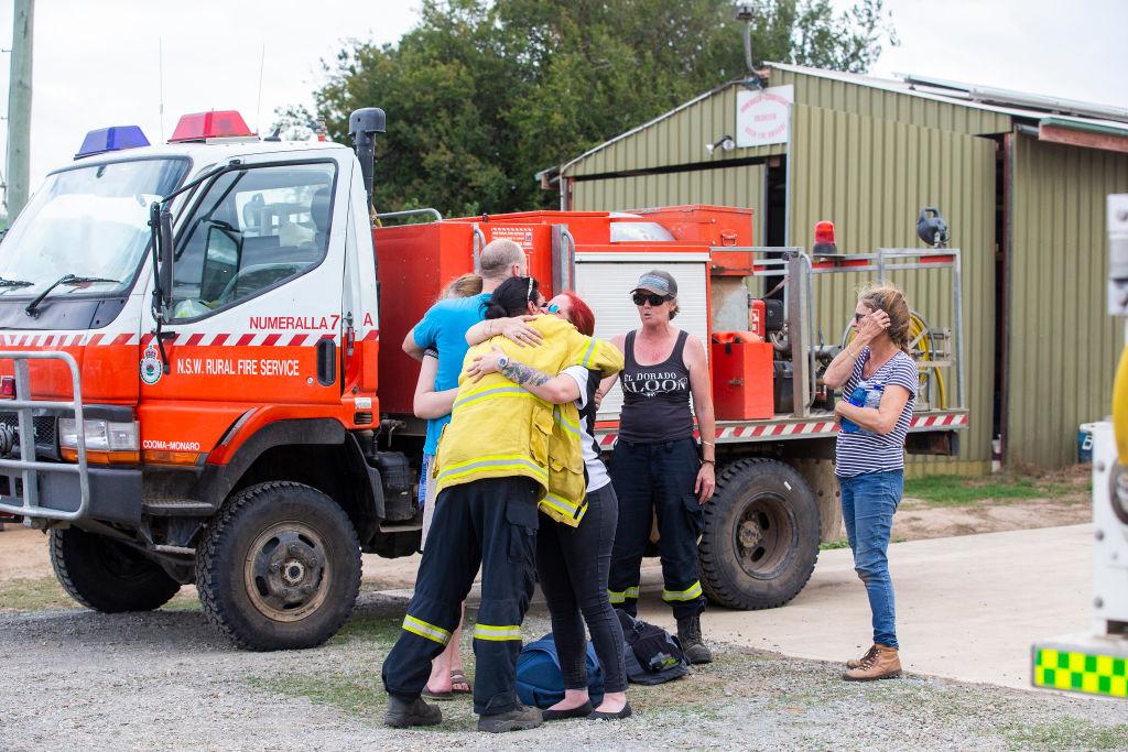 People embrace outside Numeralla Rural Fire Brigade near the scene of the water tanker plane crash in Cooma, Australia, on Jan. 23, 2020. (©Getty Images | <a href="https://www.gettyimages.com/detail/news-photo/people-are-seen-embracing-at-numeralla-rural-fire-brigade-news-photo/1201365509?adppopup=true">Jenny Evans</a>)