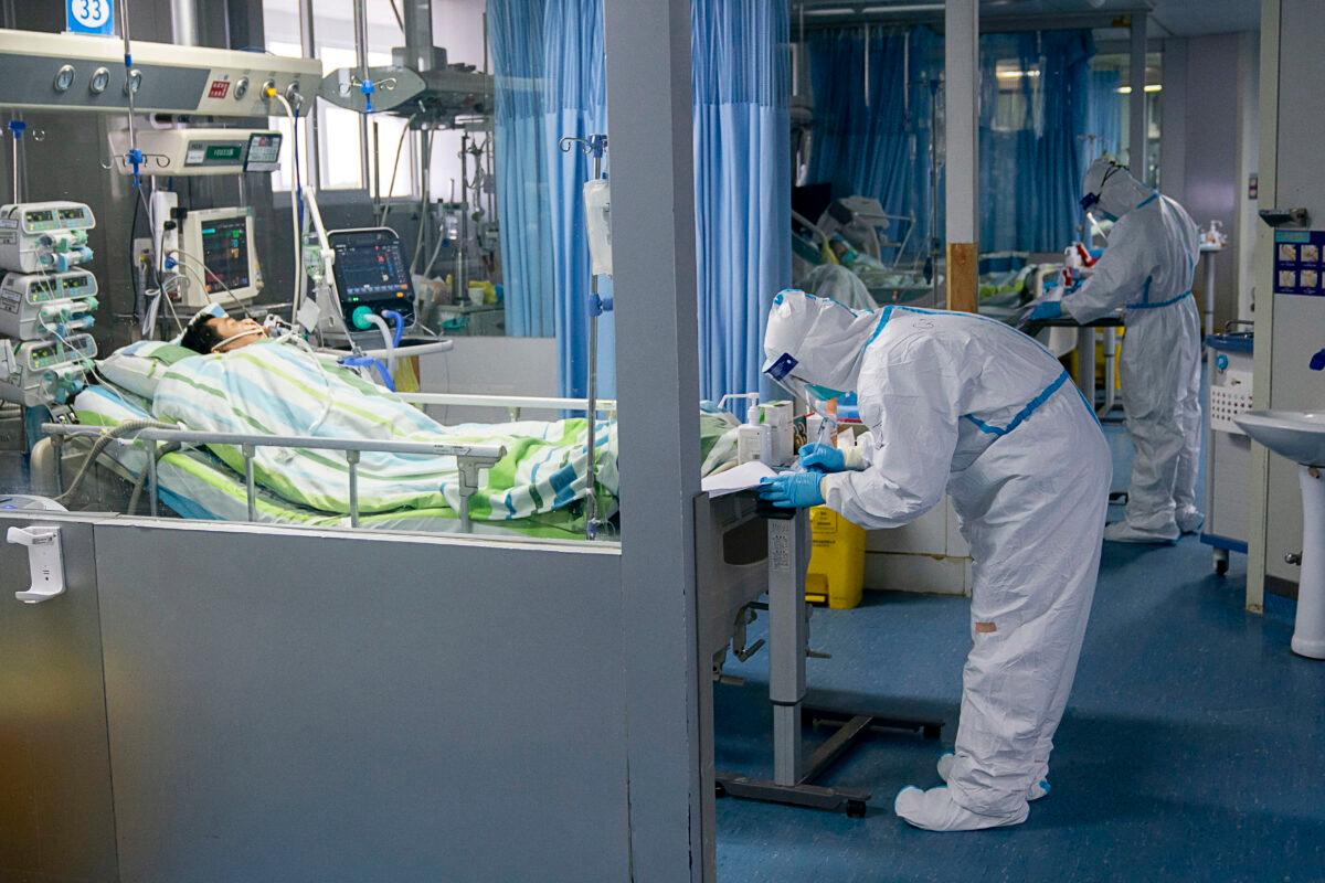 A medical worker attends to a patient in the intensive care unit at Zhongnan Hospital of Wuhan University in Wuhan in central China's Hubei Province. on Jan. 24, 2020. (Zong Qi/Xinhua via AP)
