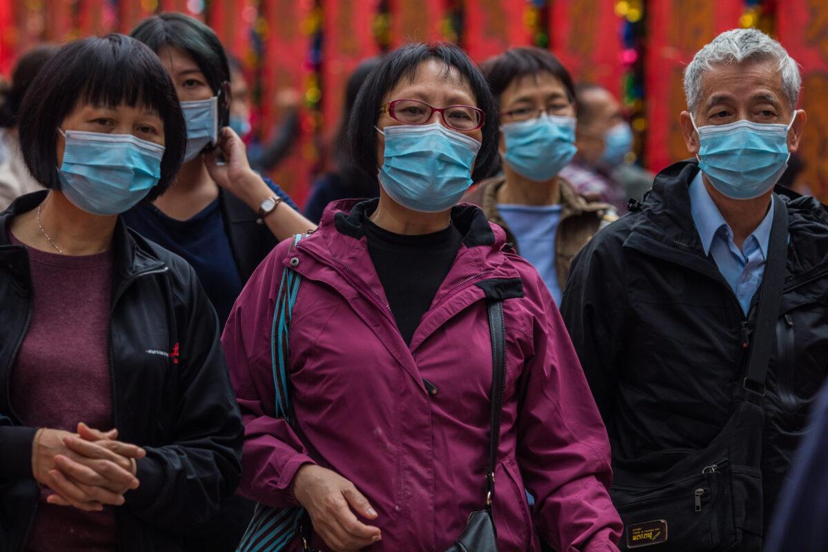 People wearing masks visit Wong Tai Sin temple in Hong Kong on Jan. 25, 2020. (Dale De La Rey/AFP via Getty Images)