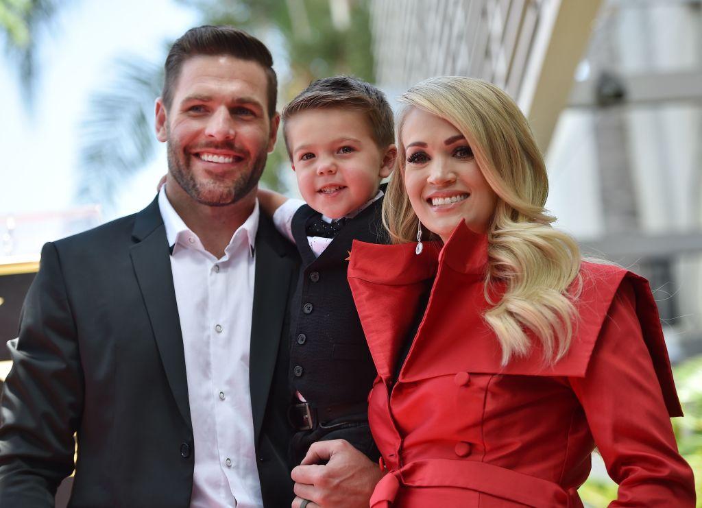 Underwood with her husband, Mike Fisher, and their son Isaiah at Underwood's star unveiling on the Hollywood Walk of Fame on Sept. 20, 2018 (©Getty Images | <a href="https://www.gettyimages.com/detail/news-photo/singer-carrie-underwood-poses-with-her-husband-mike-fisher-news-photo/1036678384?adppopup=true">ROBYN BECK</a>)