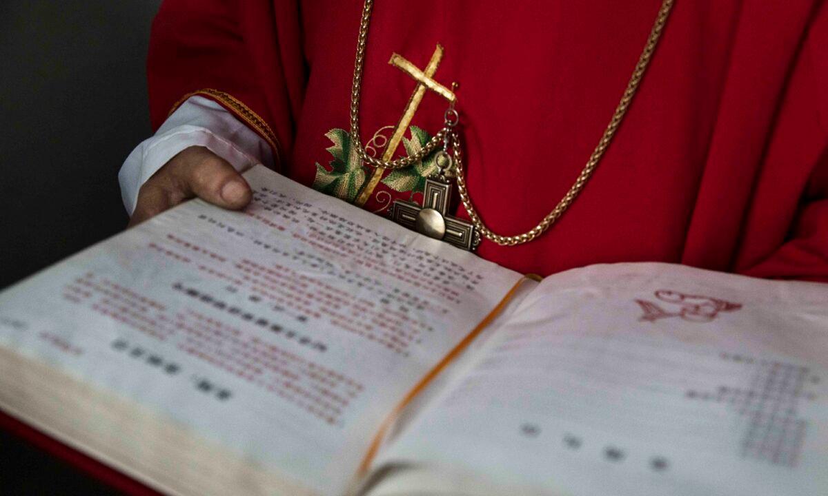 A Chinese Catholic deacon holds a bible at the Palm Sunday Mass during the Easter Holy Week at an "underground" or "unofficial" church near Shijiazhuang, Hebei Province, China, on April 9, 2017. (Kevin Frayer/Getty Images)