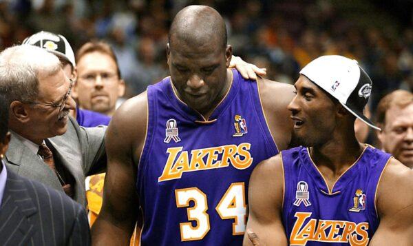 Former Los Angeles Lakers' head coach Phil Jackson (L) celebrates with former players Kobe Bryant (R) and Shaquille O'Neal (C) after at Continental Airlines Arena in June 2002. (Jeff Haynes/AFP via Getty Images).