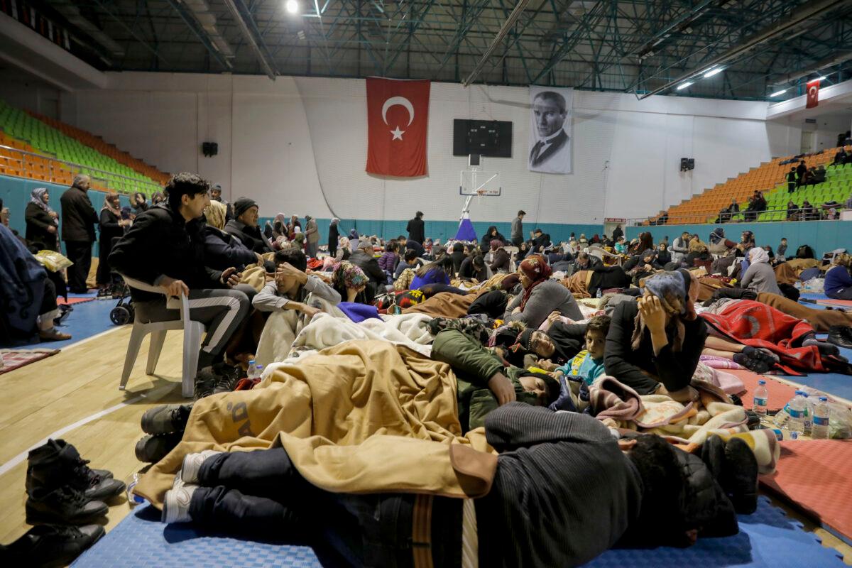 People gather inside a sports hall to spend the night following an earthquake that destroyed their houses, in Elazig, eastern Turkey, on Jan. 25, 2020. (Ugur Can/DHA via AP)