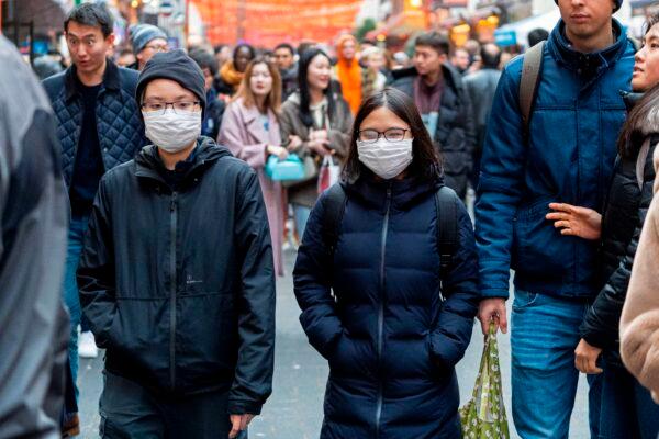 Pedestrians are seen wearing a surgical masks in London's China Town on Jan. 25, 2020. (Niklas Halle'n/AFP via Getty Images)
